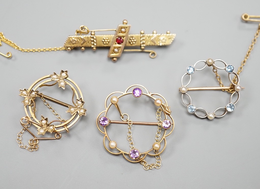 A late Victorian 9ct gold and gem set bar brooch, 43mm and a 9ct and seed pearl set open work brooch, gross 6 grams, a yellow metal amethyst and seed pearl brooch, gross 4 grams and a 15ct, aquamarine and seed pearl set